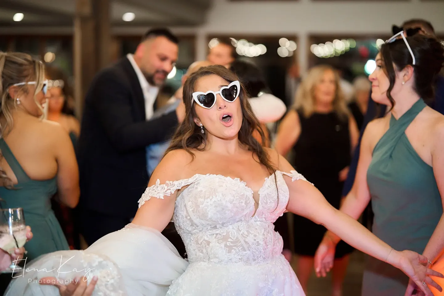 Bride dancing in heart-shaped sunglasses during the reception by Elena Kay Photography
